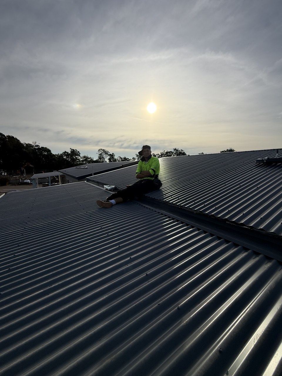 Roofer on completed metal roof